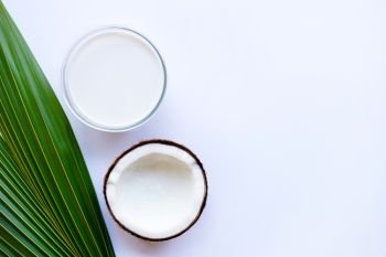 Coconut milk and coconut on  white background