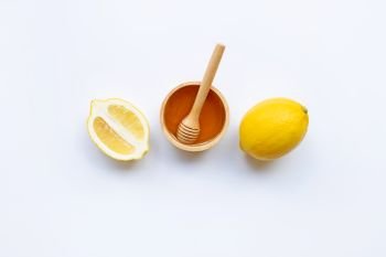 Honey with lemon on white background