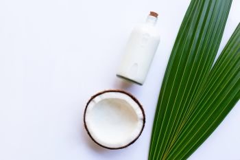 Coconut with coconut milk on white background