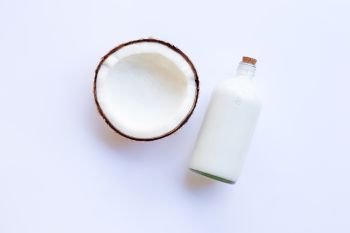 Coconut with coconut milk on white background.
