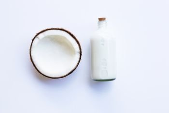 Coconut with  coconut milk on white background.