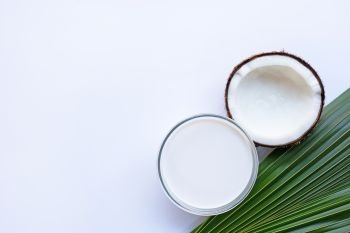 Coconut with coconut milk on white background. Copy space