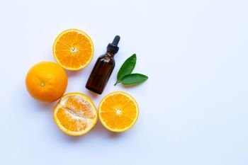 Orange essential oil on white background. Copy space