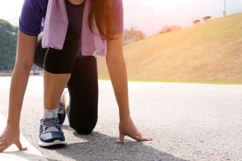 Active healthy woman tying running shoes,  jogging runner healthcare and well being concept