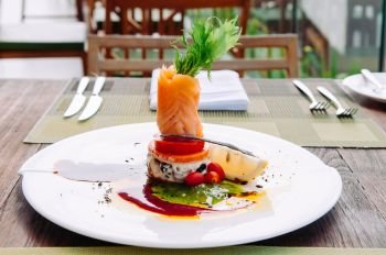 Smoked salmon salad with balsamic and pesto salad dressing, beautiful fine dining dish decoration