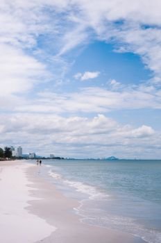 AUG 7, 2014 Hua Hin, THAILAND - Hua Hin beach peaceful sea in summer, Thailand coast  tropical beach destination with tourist walking.