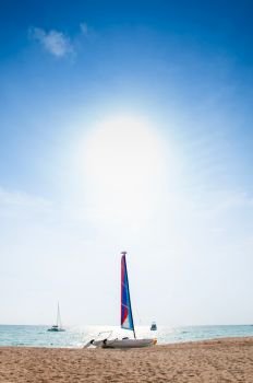 Summer at Bakantiang beach with sailboat against sun in Koh Lanta  with clear blue sky - Krabi, Thailand