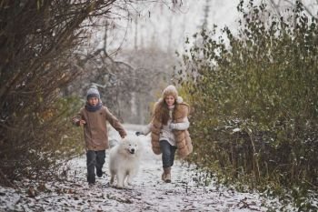 Boy and girl running a race with the Samoyed.. Children run the race with his beloved dog 9849.
