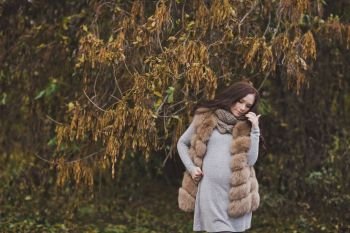 The carrier of a new life amid the fading nature.. The girl in the last months of pregnancy among the fading autumn trees 9