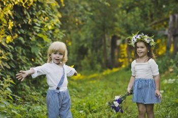 Children playing with flowers in nature.. The boy and the girl throw flowers to each other 4779.