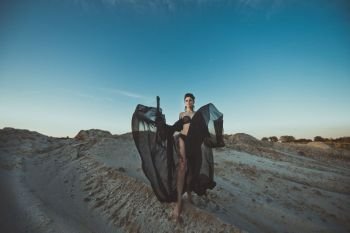 The girl in underwear among sand.. The girl in black linen among sandy dunes 3428.