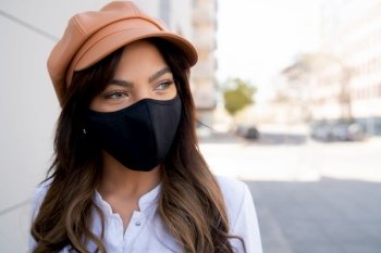Close-up of young woman wearing protective mask while standing outdoors on the street. Urban concept. New normal lifestyle concept.