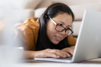 Asian women sitting using laptops at home