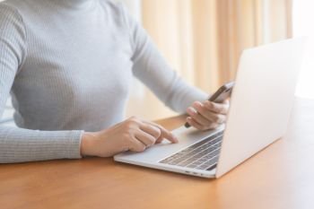 Asian women using smartphone in office, Business woman using laptop computer
