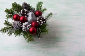 Christmas red balls and silver glitter decorations. Christmas background with fir branches and red ornaments. Christmas table centerpiece. Copy space.