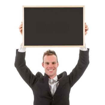 Business man holding empty chalkboard above his head, isolated on white background
