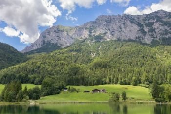 Lake Hintersee near Ramsau in Bavarian alps with blooming flowers and hotels along the lake shore. Lake Hintersee near Ramsau in Bavarian alps with hotels