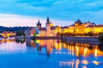 Scenic summer sunset panorama of the Old Town ancient architecture and Vltava river pier in Prague, Czech Republic
