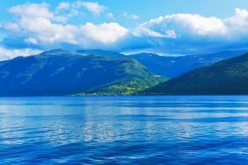 Scenic summer landscape of Sognefjord fjord in Norway, Scandinavia with high mountains, sea water and blue sky with clouds