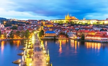 Scenic summer evening panorama of the Old Town architecture with Vltava river, Charles Bridge and St.Vitus Cathedral in Prague, Czech Republic
