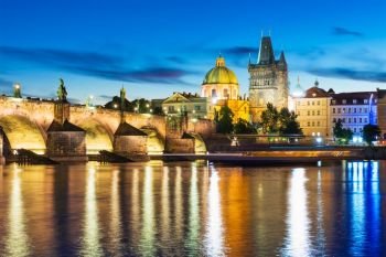 Scenic summer evening view of the Old Town ancient architecture with Vltava river pier and Charles Bridge in Prague, Czech Republic