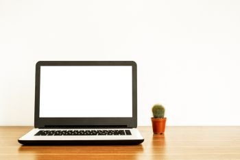 Laptop with blank screen and cactus on table. isolated on white background