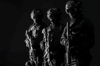 Spec ops police officers SWAT in black uniform and face mask studio shot. Spec ops police officersSWAT