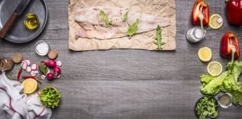 Ingredients for cooking raw cod on paper with herbs knife lemon oil pan Radisson napkin and lettuce with pepper on rustic wooden background top view border space for text banner for the web site