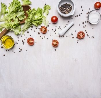 Ingredients for cooking Vegetarian Food, lettuce, cherry tomatoes, oil, salt and pepper on wooden rustic background top view close up  border ,place for text