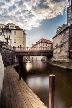 View below the Charles Bridge on the Certovka River and the colorful houses of Kampa’s Kampa Island