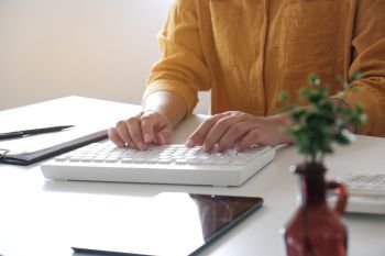 Close-up of female hands. typing in her office