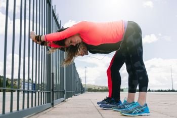 young couple stretching together before running outdoors