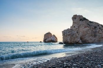 Afternoon view of breaking waves at the pebbly beach around Petra tou Romiou, in Paphos, Cyprus. It is considered to be Aphrodite’s birthplace in Greek mythology.