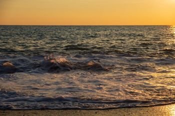 Beautiful sunset view of breaking waves at Petra tou Romiou beach, in Paphos, Cyprus. It is considered to be Aphrodite’s birthplace in Greek mythology.