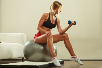 Healthy active lifestyle. Fitness woman with gym ball and dumbbell doing exercise