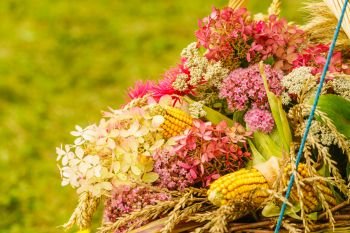 Decorative bouquet made of field flowers and hay. Folk decorations conept.. Bouquet made of field flowers and hay