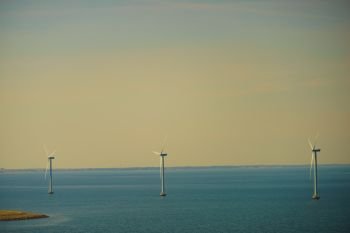 Wind turbines generator farm for renewable sustainable and alternative energy production along coast baltic sea near Denmark. Eco power, ecology.. wind turbines farm on coast