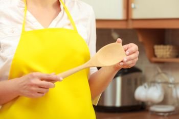 Cooking and preparing food meal concept. Part body woman chef cook housewife holding ladle spoon in kitchen.. Housewife with ladle in kitchen
