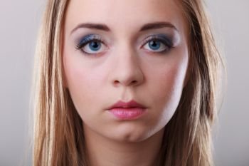 Closeup portrait attractive pensive woman, blonde blue eyes long hair girl on gray