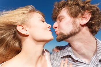 Happiness dating concept. Couple in love blonde woman handsome bearded man enjoy romantic date kissing, outdoor wide angle view. Dating. Couple in love kissing 
