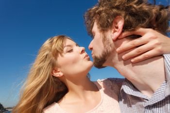 Happiness dating concept. Couple in love blonde woman handsome bearded man enjoy romantic date kissing, outdoor wide angle view. Dating. Couple in love kissing 