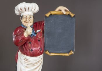 wooden decorative cook holding poster, dressed in typical chef clothing