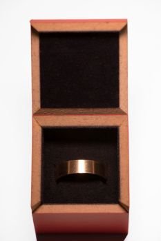 A golden blank ring in box