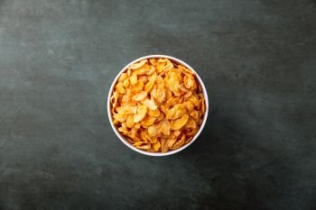 Cornflakes in a bowl on a nice underground, top view