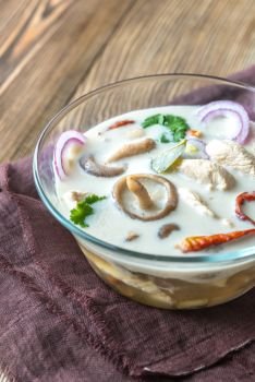 Glass bowl of thai tom kha kai soup