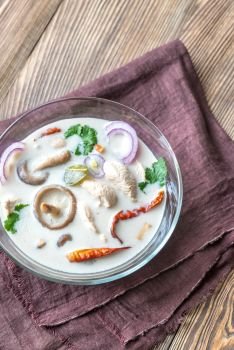 Glass bowl of thai tom kha kai soup