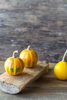Ornamental pumpkins on the wooden background