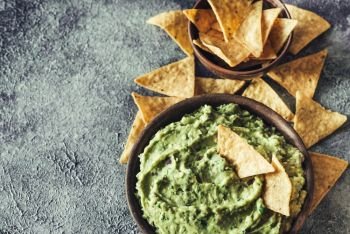 Guacamole in bowl with tortilla chips