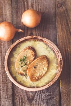 Bowl of onion soup on the wooden table