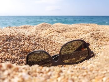 Sunglasses on the sand beach